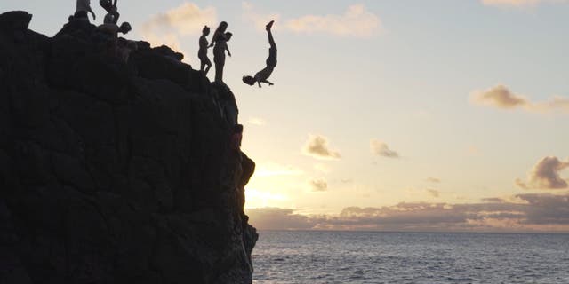 Family going cliff jumping in 'The Homeschool Awakening'