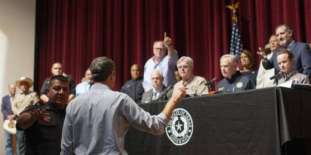 Democrat Beto O'Rourke, who is running against Greg Abbott for governor in 2022, interrupts a news conference headed by Texas Gov. Greg Abbott in Uvalde, Texas Wednesday, May 25, 2022. 