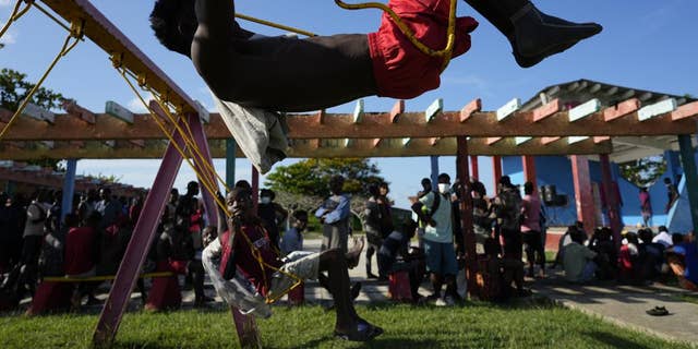 A Haitian migrant swings at a tourist campground in Sierra Morena, in the Villa Clara province of Cuba Wednesday, May 25, 2022.
