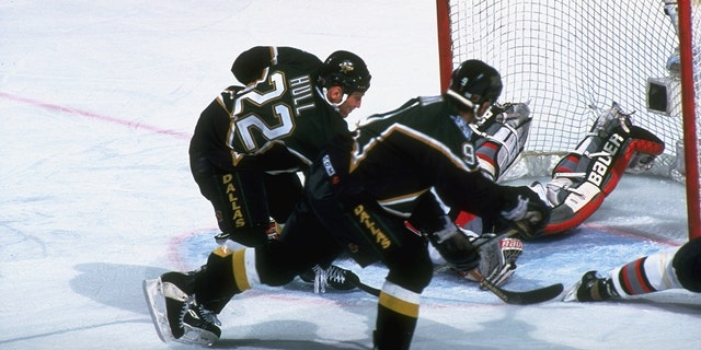 Dallas Stars' Brett Hull scores the game-winning goal against the Sabres in the NHL Finals in Buffalo, New York, June 19, 1999.