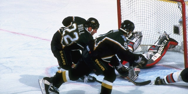 Dallas Stars' Brett Hull scores the game-winning goal against the Sabres in the NHL Finals in Buffalo, New York, June 19, 1999.