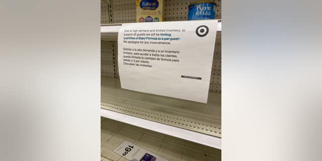 Signs at a Target inform shoppers that they are limited to four containers each due to the shortage in baby formula.