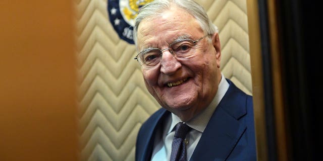Former Vice President Walter Mondale smiles as he climbs into an elevator on Capitol Hill in Washington, Jan. 3, 2018. Biden plans to speak at a memorial service in Minnesota on Sunday, May 1, for Mondal, who died last April at the age of 93.