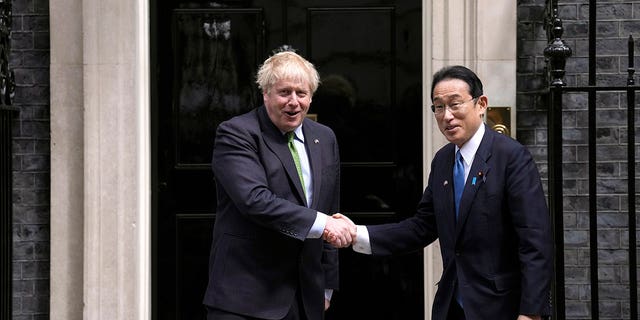 British Prime Minister Boris Johnson, left, greets Japanese Prime Minister Fumio Kishida before their meeting at 10 Downing Street in London, Thursday, May 5, 2022. 