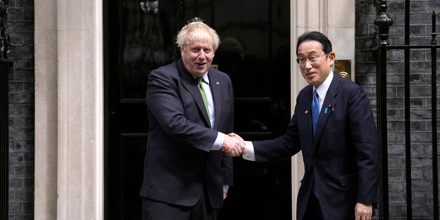 Britain's Prime Minister Boris Johnson, left, greets Japanese Prime Minister Fumio Kishida before they meet at 10 Downing Street in London, Thursday, May 5, 2022.