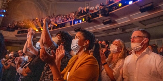 NEW YORK, NEW YORK - SEPTEMBER 14: Audience members scream and applaud during "Chicago" at Ambassador Theatre on reopening night on September 14, 2021 in New York City. 