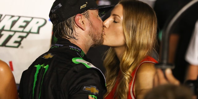 Kurt Busch kisses his wife Ashley Van Metre after winning the Quaker State 400 at Kentucky Speedway in Sparta, Ky., July 13, 2019.