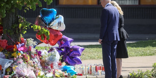 U.S. President Joe Biden and first lady Jill Biden look at a memorial in the wake of a weekend shooting at a Tops supermarket in Buffalo, New York, U.S. May 17, 2022.