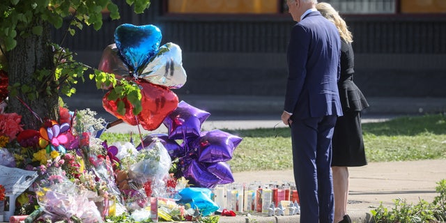 U.S. President Joe Biden and first lady Jill Biden look at a memorial in the wake of a weekend shooting at a Tops supermarket in Buffalo, New York, U.S. May 17, 2022.  