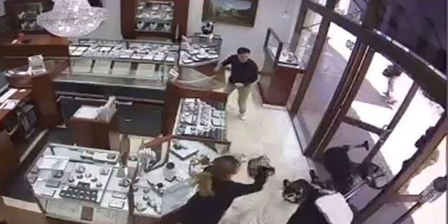 Surveillance video from Princess Bride Diamonds shows workers fight off smash and grab robbers at Bella Terra mall in Huntington Beach, California. 