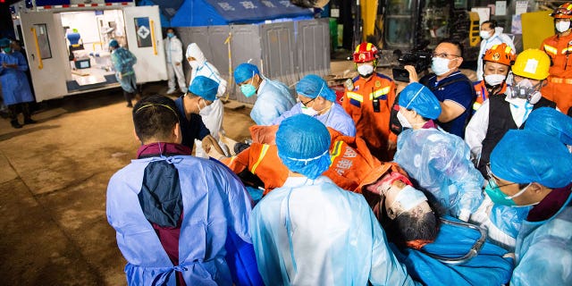 In this photo released by Xinhua News Agency, medical workers evacuate the 10th survivor pulled alive after being trapped 132 hours from the debris of a self-built residential structure that collapsed in Changsha in central China's Hunan Province on Thursday May 5, 2022. Rescuers in central China have pulled the woman alive from the rubble of a building that partially collapsed almost six days earlier, state media reported Thursday. (Chen Sihan/Xinhua via AP)