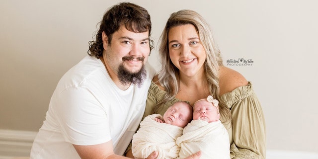 Kentucky parents Dalton and Cierra Vos are shown in a photo snapped in 2021 as they hold their twins, Landrie and Rollyn, now 9 months old.