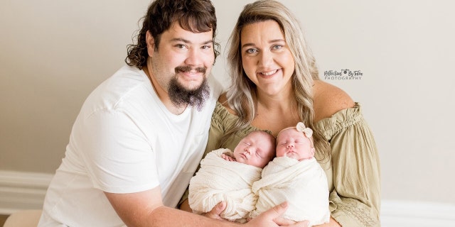Kentucky parents Dalton and Cierra Vos are shown in a photo taken in 2021 holding their twin boys, Landrie and Rollyn, now 9 months old.