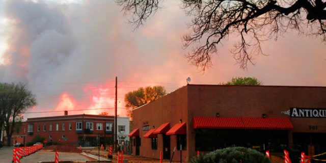 A sunset seen through a wall of wildfire smoke from Las Vegas, N.M., on Saturday, May 7, 2022. Area residents have been on and off of evacuation orders of the past month as fires grow and move with intense and unpredictable winds. 