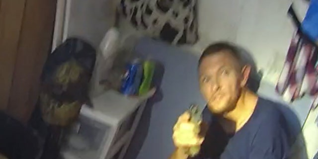 Dewayne Davis, 35, is seen in this still image taken from a deputy's bodycam pointing a handgun at deputies, the sheriff's office said.