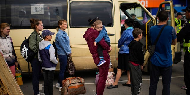 People wait to be processed upon their arrival at a reception center for displaced people in Zaporizhzhia, Ukraine, Monday, May 2, 2022. Thousands of Ukrainian continue to leave Russian occupied areas. (G3 Box News Photo/Francisco Seco)