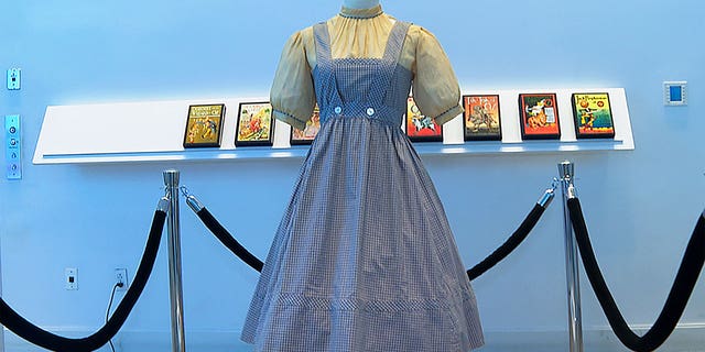 The gingham dress, worn by Judy Garland in the "Wizard of Oz" hangs on display, April 25, 2022, at Bonhams in New York.