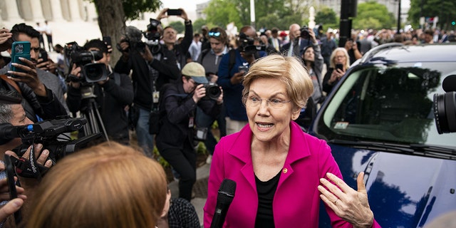 Senator Elizabeth Warren, a Democrat from Massachusetts, speaks to members of the media during a protest outside the U.S. Supreme Court in Washington, D.C., U.S., on Tuesday, May 3, 2022.( Al Drago/Bloomberg via Getty Images)