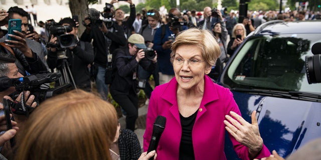 Sen. Elizabeth Warren, a Democrat from Massachusetts, speaks to members of the media during a protest outside the Supreme Court in Washington, D.C.