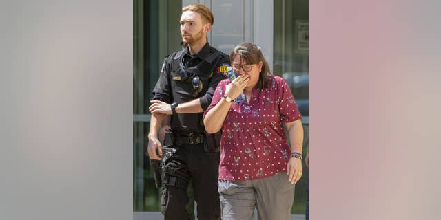 A woman cries as she leaves the Uvalde Civic Center following a shooting earlier today at Robb Elementary School, Tuesday, May 24, 2022, in Uvalde, Texas.