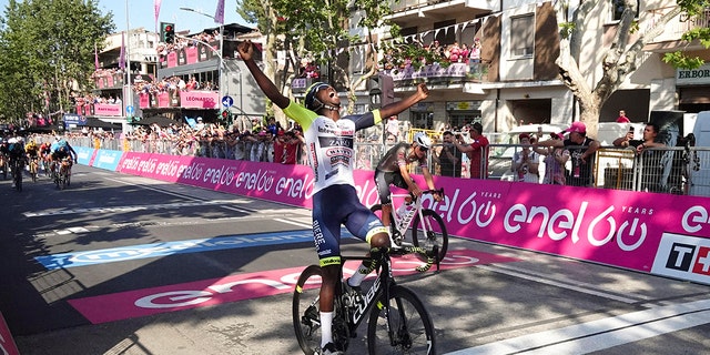 Eritrea's Biniam Girmay celebrates as he crosses the finish line Tuesday, May 17, 2022.