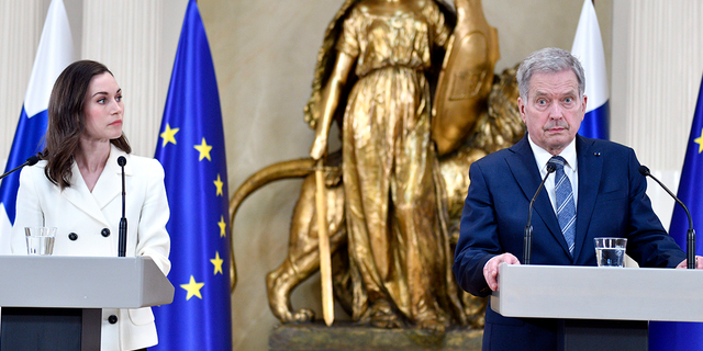 Finland's President Sauli Niinisto and Prime Minister Sanna Marin, left, attend the press conference on Finland's security policy decisions at the Presidential Palace in Helsinki, Finland, on Sunday May 15. (Heikki Saukkomaa/Lehtiuva via AP)