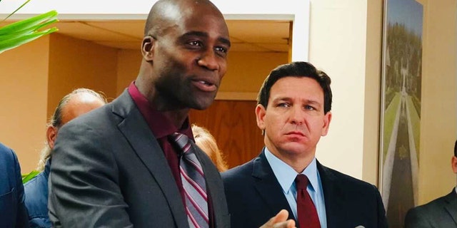 Florida Surgeon General Joseph Ladapo and Gov.  Ron DeSantis at a news conference in West Palm Beach, Florida.
