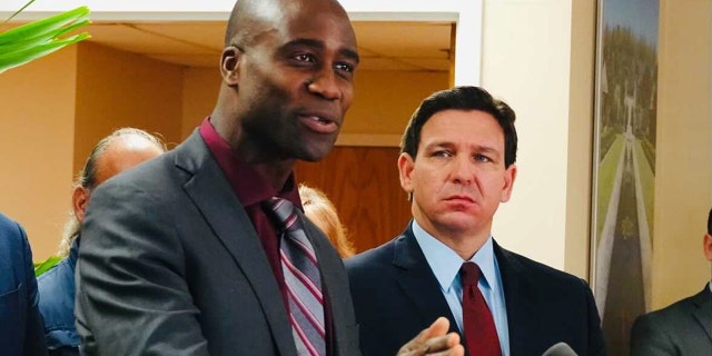 Florida Surgeon General Joseph Ladapo and Gov.  Ron DeSantis at a news conference in West Palm Beach, Florida.