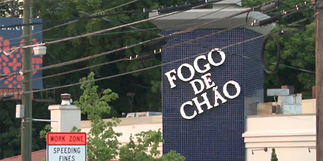 The sign of the Fogo de Chao Brazilian steakhouse in Atlanta where police say an officer shot and killed a man who first opened fire on a security guard. 