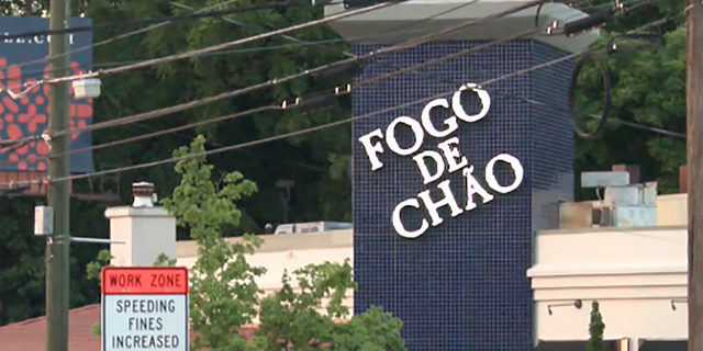 The sign of the Fogo de Chao Brazilian steakhouse in Atlanta where police say an officer shot and killed a man who first opened fire on a security guard.