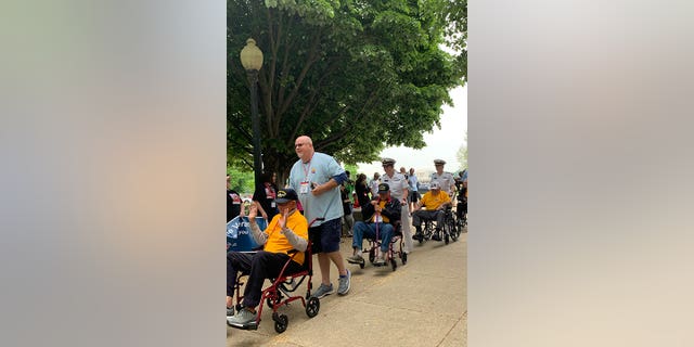 Veterans are assisted during a trip, courtesy of Honor Flight Network, to Washington, 直流电, to visit and experience the memorials recognizing and respecting their service and sacrifice.