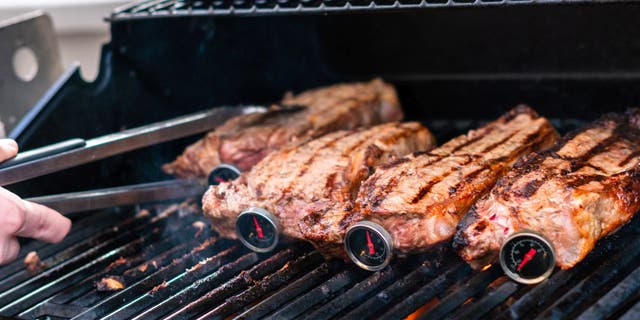 Steaks cooking on a grill