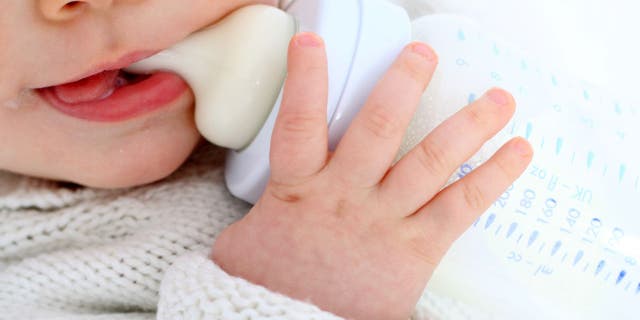 Baby drinks from bottle