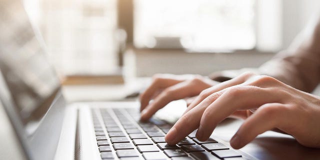 Typing on laptop closeup, chatting on facebook, meeting website. Bloggers, journalists write new articles.