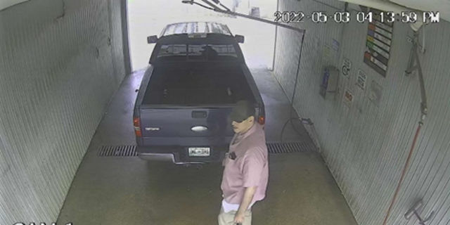 This photo provided by the U.S. Marshals Service May 9, 2022, shows a man standing next to a 2006 Ford F-150 that had been abandoned at a car wash in the 2000 block of South Weinbach Avenue in Evansville, Ind.