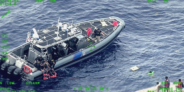 Rescue craft arrive on scene after a migrant vessel capsized north of Desecheo Island, Puerto Rico May 12, 2022 in a still image from surveillance aircraft video.  United States Coast Guard/Handout via REUTERS.  