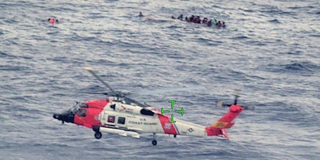 A U.S. Coast Guard helicopter arrives on scene after a migrant vessel capsized north of Desecheo Island, Puerto Rico May 12, 2022 in a still image from surveillance aircraft video. (United States Coast Guard/Handout via REUTERS.) 