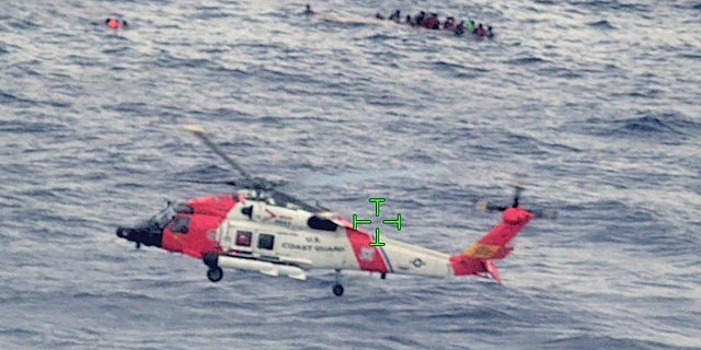 A U.S. Coast Guard helicopter arrives on scene after a migrant vessel capsized north of Desecheo Island, Puerto Rico May 12, 2022 in a still image from surveillance aircraft video. (United States Coast Guard/Handout via REUTERS.)