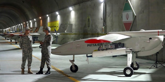 In this photo released on Saturday, May 28, 2022 by website of the Iranian Army, Chief of the General Staff of the Armed Forces Gen. Mohammad Hossein Bagheri, left, and Commander of the Army Gen. Abdolrahim Mousavi talk while visiting an underground drone base tunnel of the Army in the heart of the country's western Zagros Mountains. Iranian state television's report said Saturday, May 29, the tunnel was some 100 meters (330 feet) underground and was home to the Kaman-22 and Fotros drones, both capable of carrying cruise missiles.