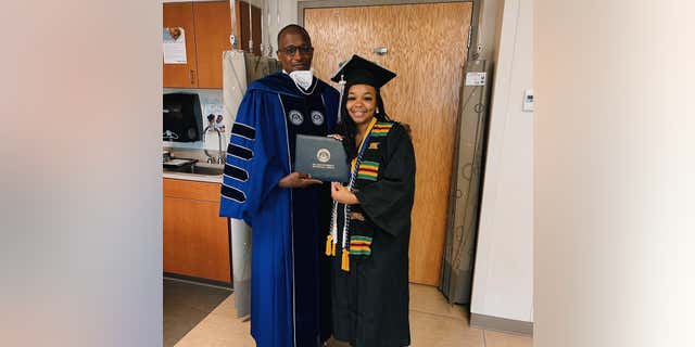 Jada Sayles stands with Dr. Walter Kimbrough, who is Dillard University's president and Sayles' mentor. Sayles kept Kimbrough informed of her pregnancy journey.