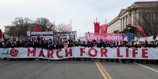 Pro-life activists march during the 49th annual March for Life rally on the National Mall on January 21, 2022 in Washington, DC. The rally draws activists from around the country who are calling on the U.S. Supreme Court to overturn the Roe v. Wade decision that legalized abortion nationwide.