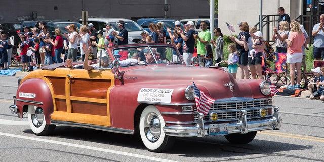 The post-war Chrysler Town and Country was a celebration of American excellence and makes a grand platform for the country's heroes at Naperville's parade.