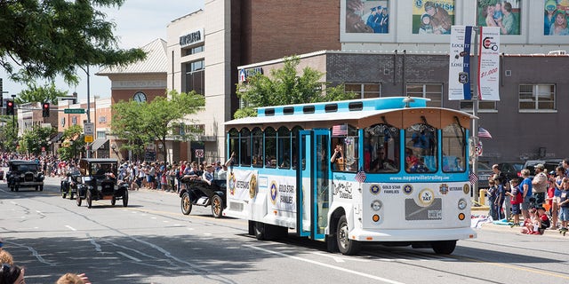 The retro Naperville Trolley fits right in with the parade's antique cars and helps transport veterans and Gold Star families.