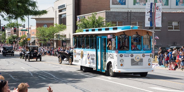 The retro Naperville Trolley fits right in with the parade's antique cars and helps transport veterans and Gold Star families.