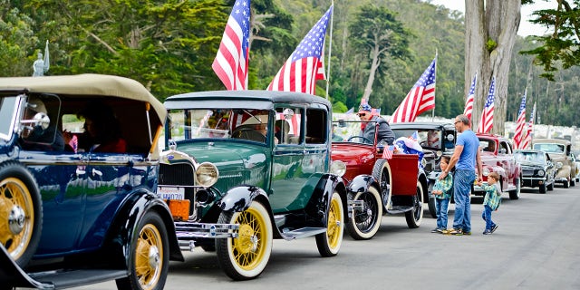 Memorial Day parade with cars and flags