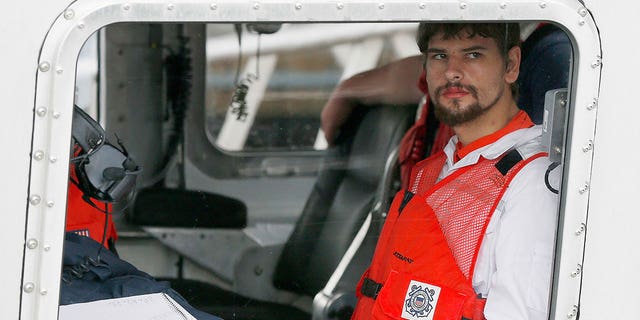 Nathan Carman arrives in a small boat at the U.S. Coast Guard station in Boston, Sept. 27, 2016.