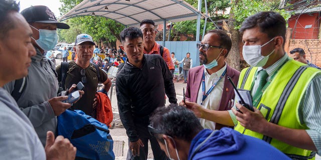 A team of climbers prepares to leave for rescue operations from the Tribhuvan International Airport in Kathmandu, Nepal, Sunday, May 29, 2022. A small airplane with 22 people on board flying on a popular tourist route was missing in Nepal’s mountains Sunday, an official said. 
