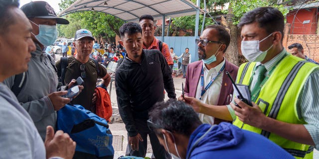A team of climbers prepares to leave for rescue operations from the Tribhuvan International Airport in Kathmandu, Nepal, Sunday, May 29, 2022. A small airplane with 22 people on board flying on a popular tourist route was missing in Nepal’s mountains Sunday, an official said.