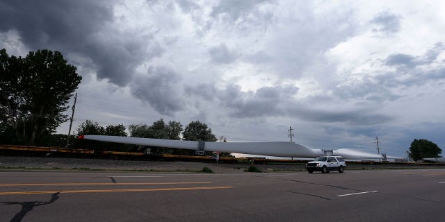 In this June 30, 2016, file photo, a train carries blades for wind turbines bound for another state through Rocky Ford, Colo., in Otero County.