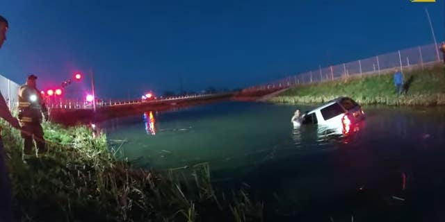 New York State Police and Evans Mills firefighters rescued a woman trapped inside a vehicle that crashed into a retention pond last week.